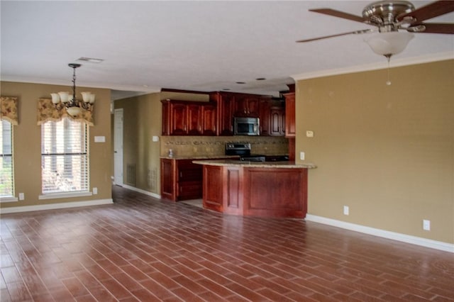 kitchen with pendant lighting, ceiling fan with notable chandelier, ornamental molding, appliances with stainless steel finishes, and tasteful backsplash