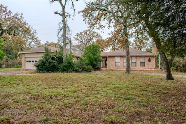 ranch-style home with a front yard and a garage