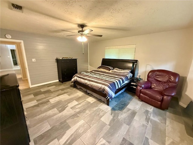 65 Navarro Dr, Hilltop Lakes, TX 77871 - bedroom featuring baseboards, a textured ceiling, and ceiling fan