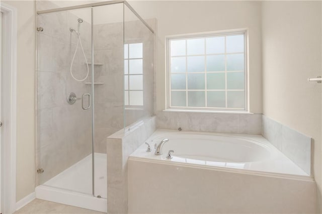 bathroom featuring shower with separate bathtub