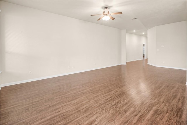 unfurnished room featuring dark wood-type flooring and ceiling fan