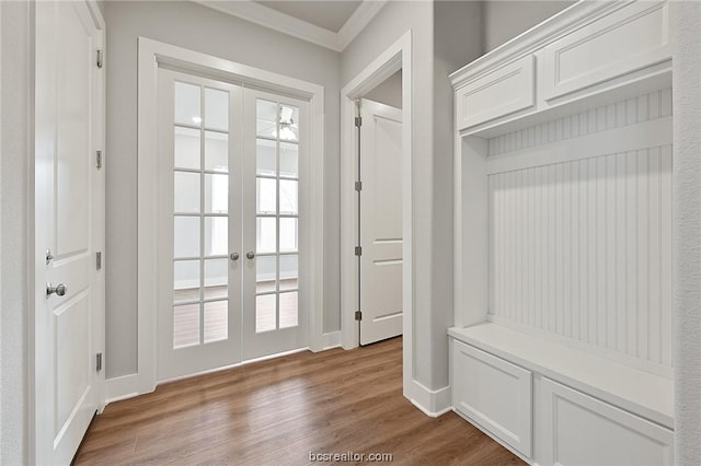 mudroom with wood-type flooring, ornamental molding, and french doors