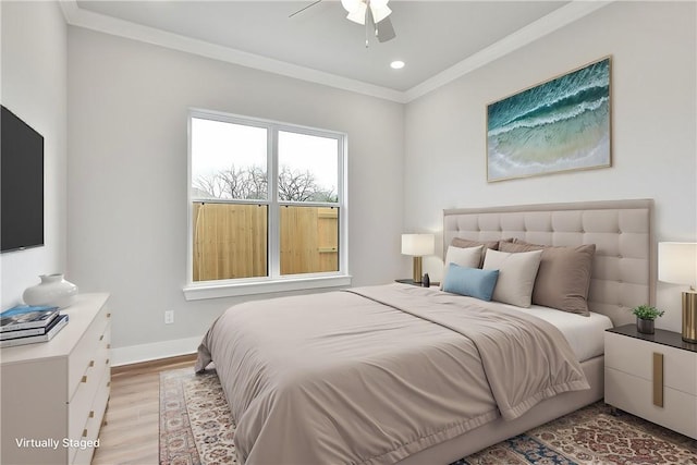 bedroom featuring light hardwood / wood-style flooring, ceiling fan, and ornamental molding