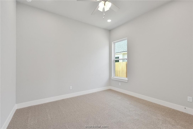 spare room with carpet and ceiling fan