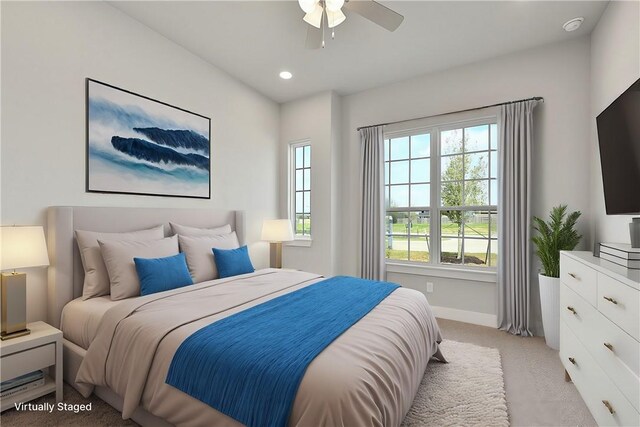 bedroom with ceiling fan and light colored carpet