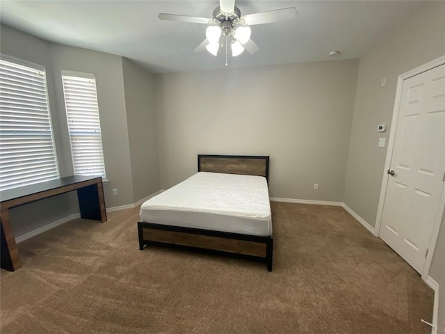 bedroom with ceiling fan and dark carpet