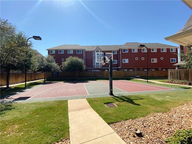 view of basketball court with a lawn