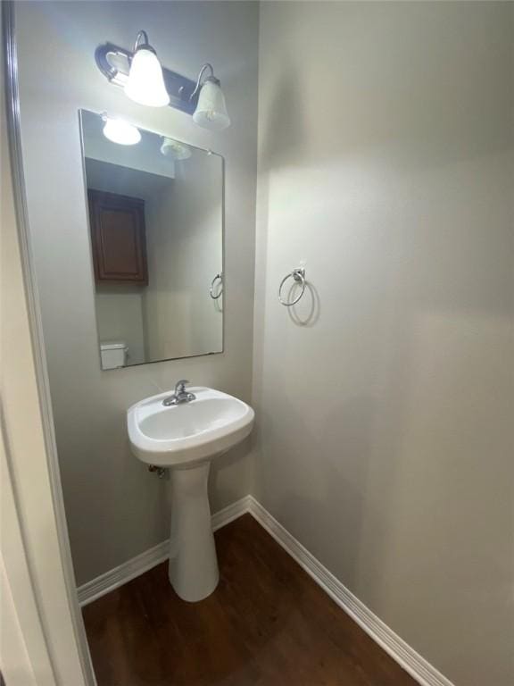 bathroom featuring toilet and wood-type flooring