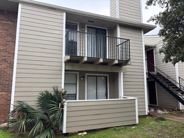 back of house featuring a balcony