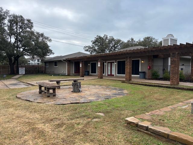 back of house with a yard and a patio