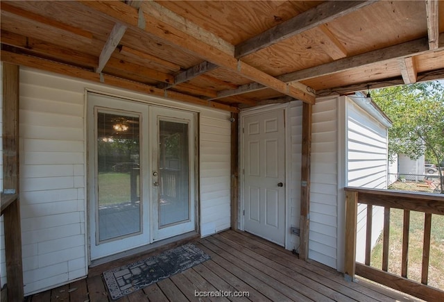 view of exterior entry with a wooden deck