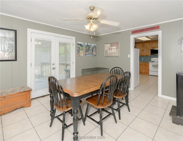 dining room with ceiling fan, light tile patterned flooring, ornamental molding, and french doors