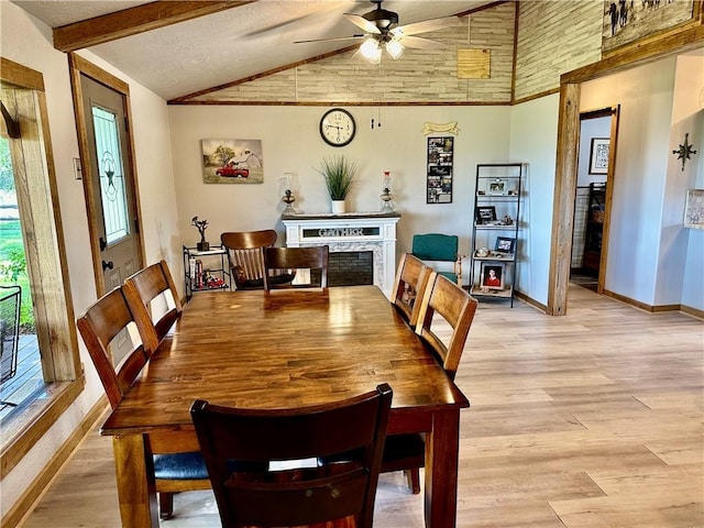 dining room with baseboards, vaulted ceiling with beams, ceiling fan, and a healthy amount of sunlight