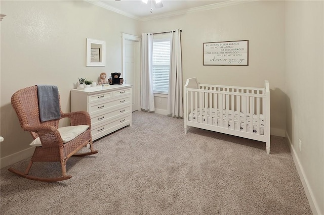 bedroom with crown molding, a nursery area, and light carpet