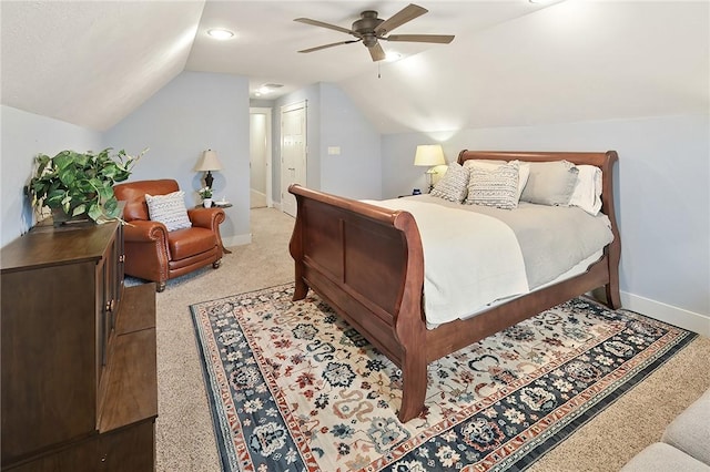 bedroom with vaulted ceiling, light colored carpet, and ceiling fan