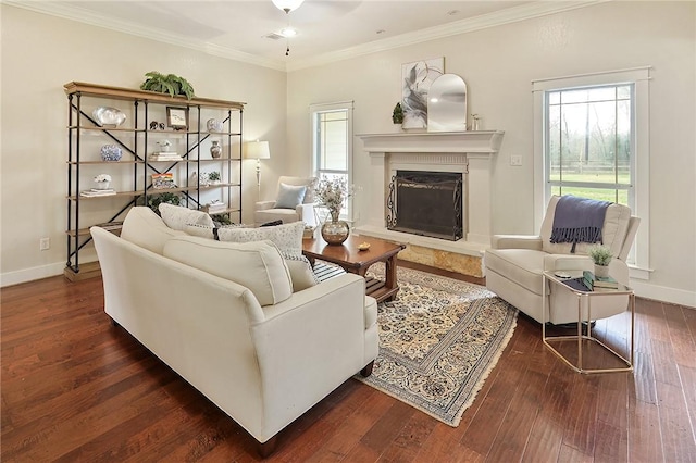 living room with dark wood-type flooring, ornamental molding, and a high end fireplace