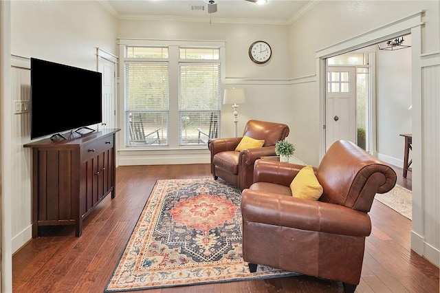 living area with ornamental molding and dark hardwood / wood-style floors