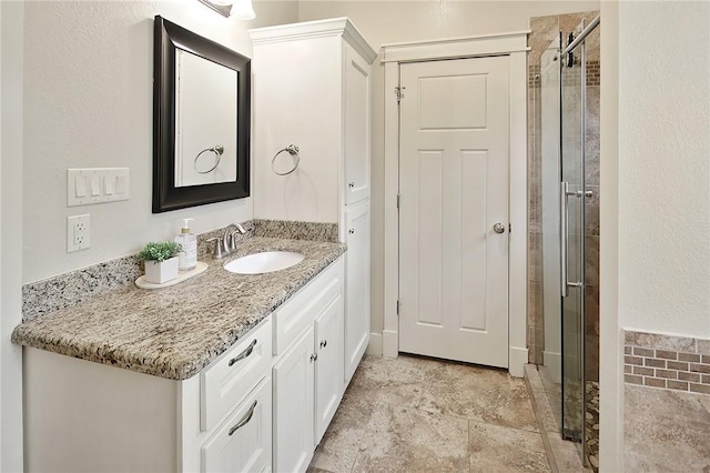 bathroom with vanity and an enclosed shower