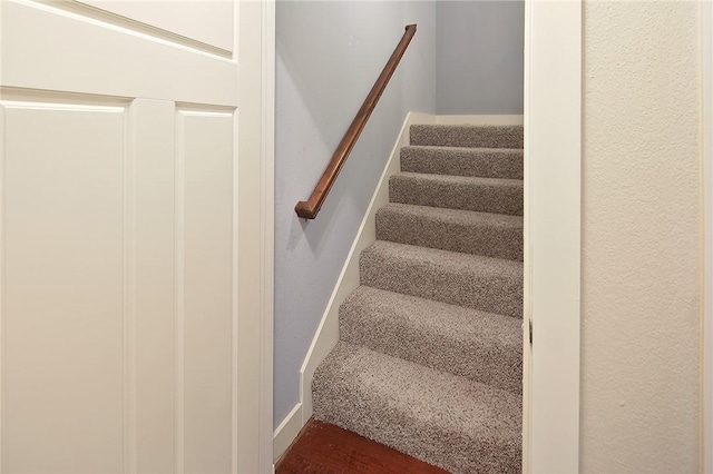 stairs featuring hardwood / wood-style floors