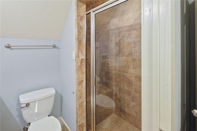 bathroom featuring an enclosed shower and toilet