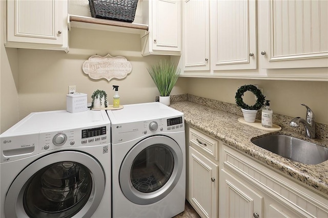 laundry area featuring cabinets, sink, and independent washer and dryer