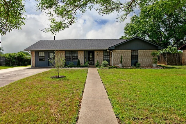 ranch-style house featuring roof with shingles, brick siding, fence, a front lawn, and concrete driveway