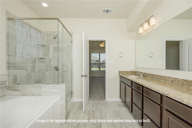 bathroom featuring ceiling fan, vanity, and independent shower and bath