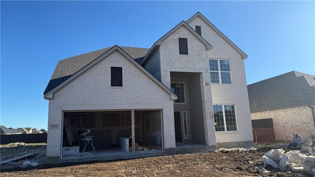 rear view of property with a garage