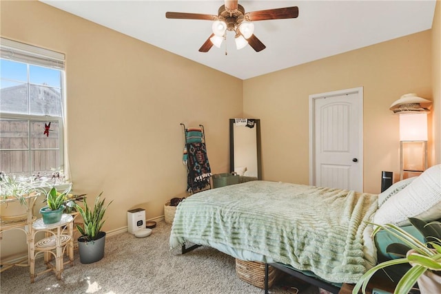 bedroom featuring baseboards, a ceiling fan, and carpet