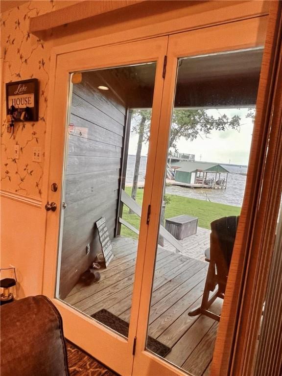 doorway to outside with a water view