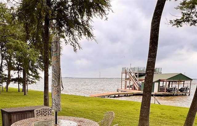 dock area featuring a lawn and a water view