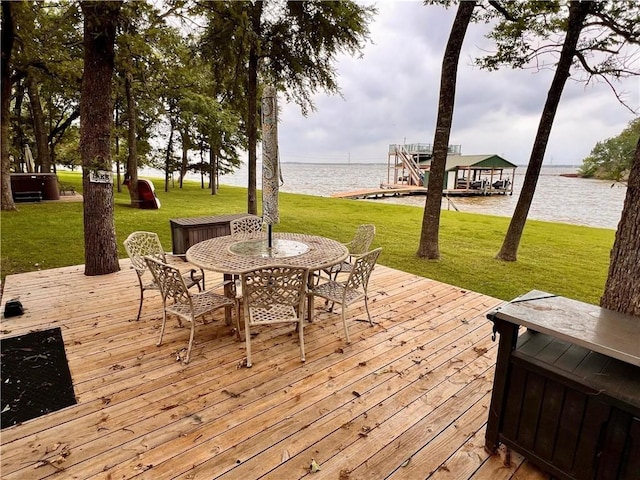 wooden deck with a lawn and a water view