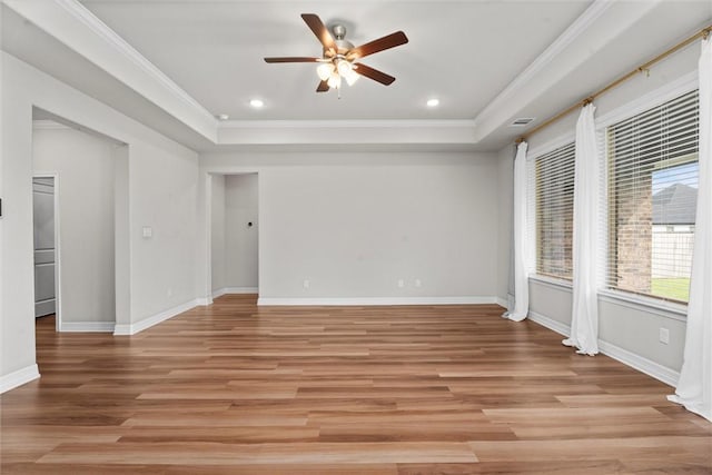 3008 Alpha Ct, Bryan, TX 77808 - empty room with a tray ceiling, ornamental molding, a ceiling fan, light wood-type flooring, and baseboards
