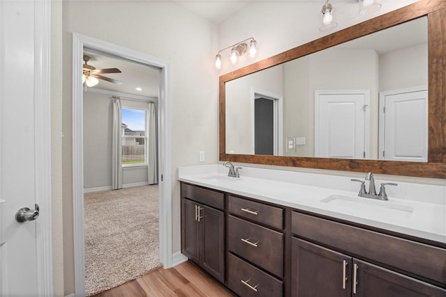 3008 Alpha Ct, Bryan, TX 77808 - full bathroom with double vanity, wood finished floors, and baseboards