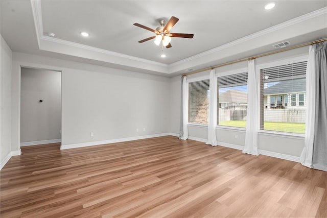 3008 Alpha Ct, Bryan, TX 77808 - empty room with a ceiling fan, a tray ceiling, crown molding, light wood-style floors, and baseboards