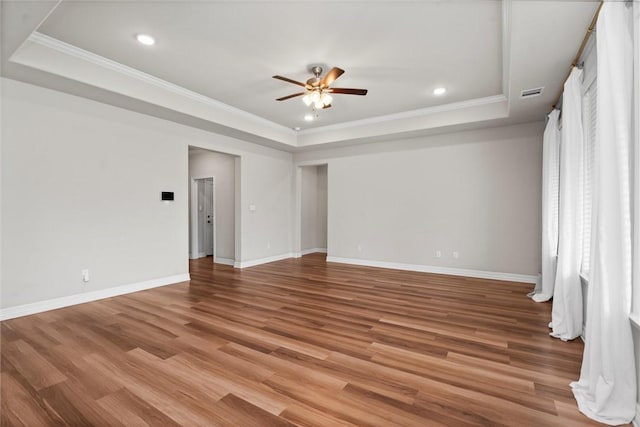 3008 Alpha Ct, Bryan, TX 77808 - empty room featuring a tray ceiling, a ceiling fan, recessed lighting, crown molding, and light wood-type flooring