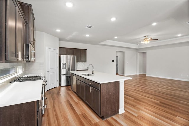 3008 Alpha Ct, Bryan, TX 77808 - kitchen with appliances with stainless steel finishes, a sink, dark brown cabinets, backsplash, and recessed lighting