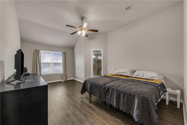 bedroom with connected bathroom, ceiling fan, dark hardwood / wood-style flooring, and lofted ceiling