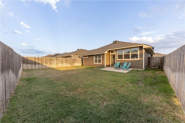 rear view of property featuring a lawn and a patio