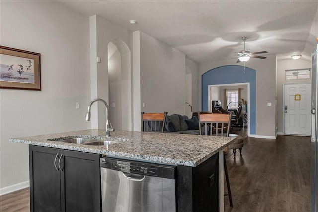 kitchen featuring stainless steel dishwasher, dark hardwood / wood-style floors, sink, and a kitchen island with sink