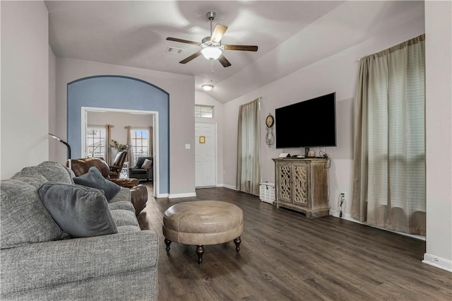 living room featuring ceiling fan, dark wood-type flooring, and vaulted ceiling