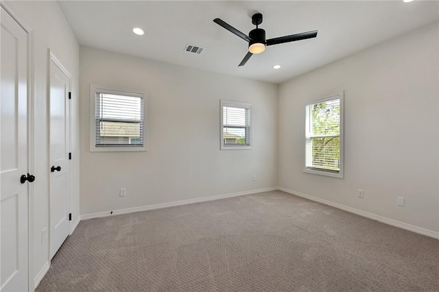 unfurnished bedroom featuring light carpet, baseboards, visible vents, and recessed lighting