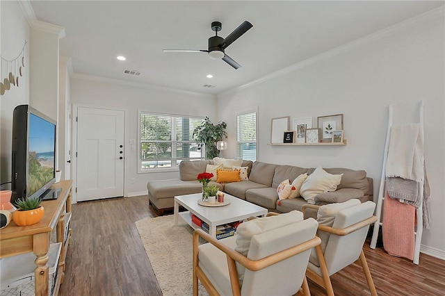 living room featuring ceiling fan, crown molding, wood finished floors, and visible vents