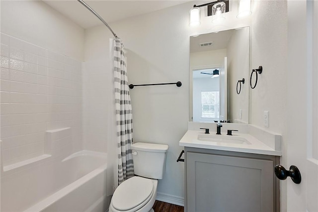 bathroom featuring shower / bath combo, toilet, vanity, and visible vents