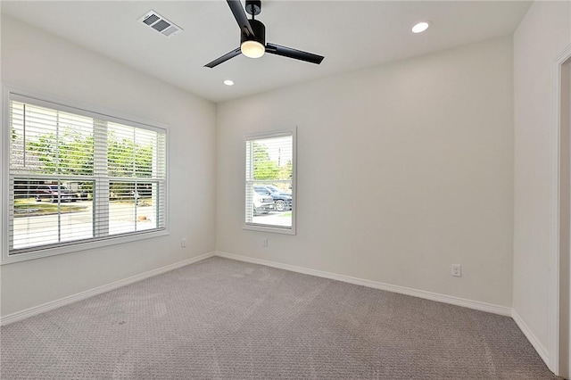 unfurnished room featuring recessed lighting, visible vents, a ceiling fan, and light carpet