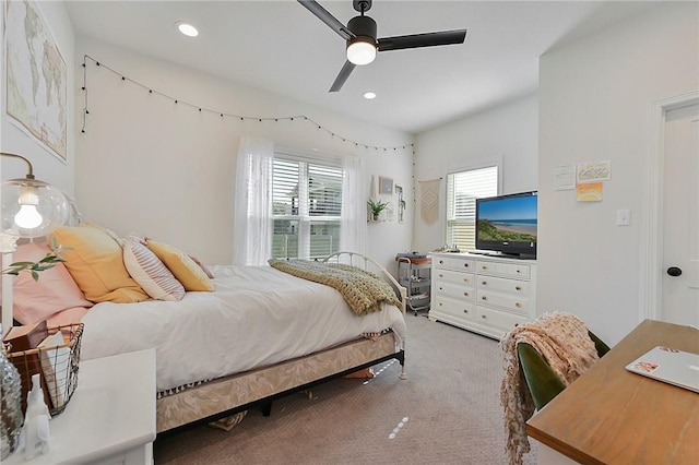 carpeted bedroom featuring recessed lighting, a ceiling fan, and multiple windows