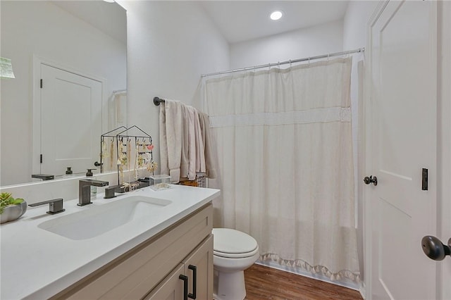 full bathroom featuring curtained shower, wood finished floors, toilet, and vanity