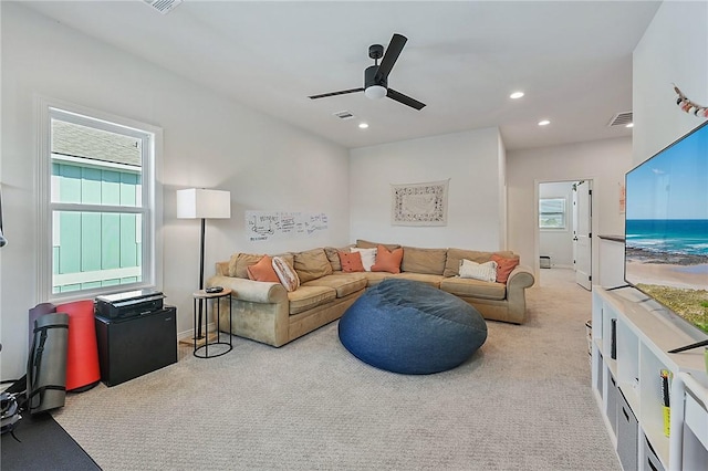carpeted living room featuring a ceiling fan, visible vents, and recessed lighting