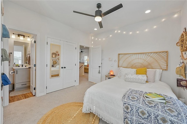 bedroom featuring recessed lighting, light colored carpet, ceiling fan, and connected bathroom
