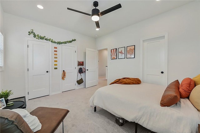 bedroom with recessed lighting, ceiling fan, and light carpet